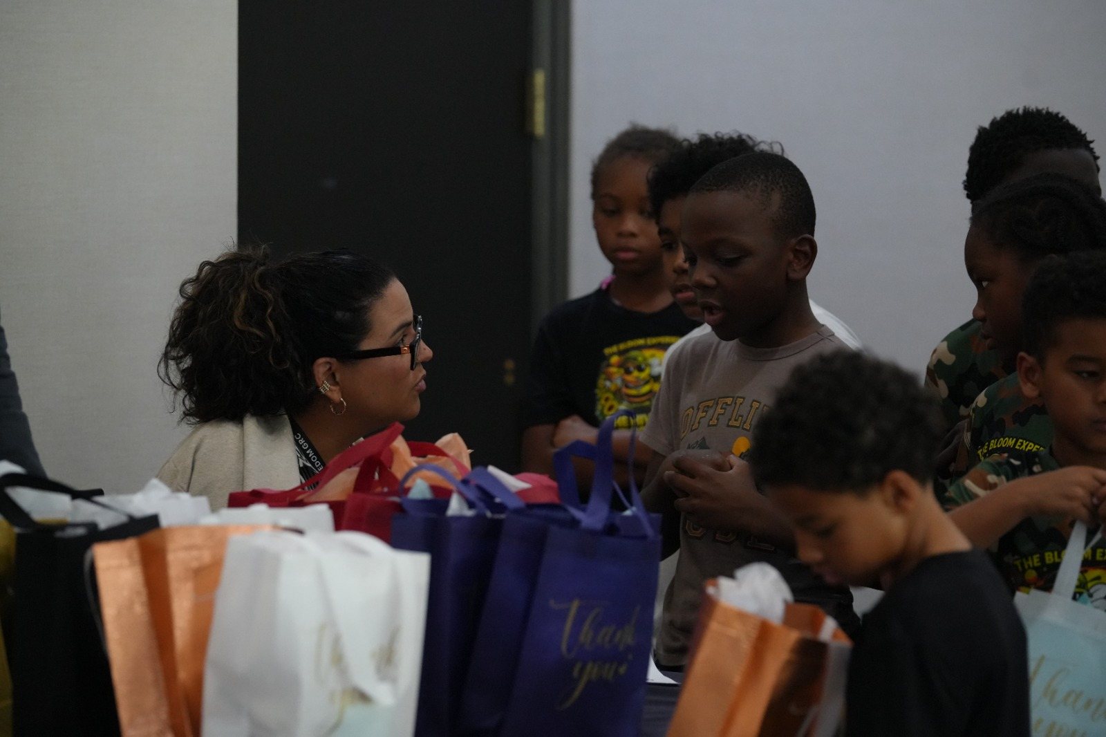 Children receive prepared gift bags during a community outreach activity