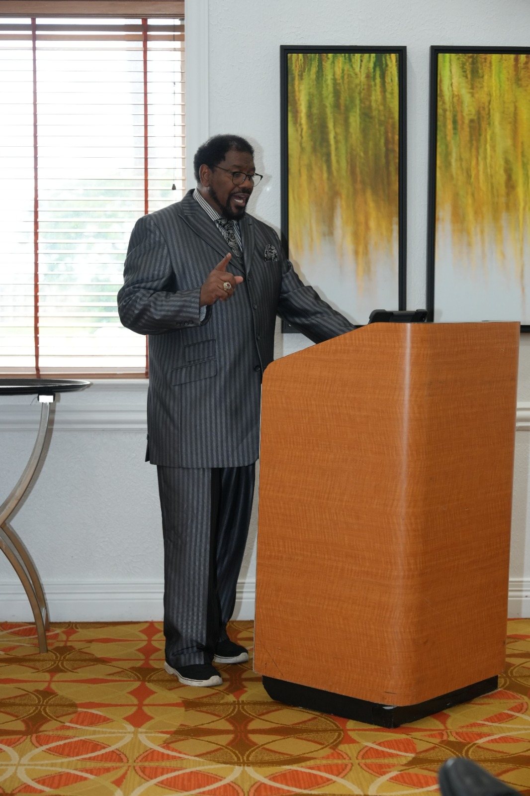 A minister addresses a FreedomGRC session from a podium